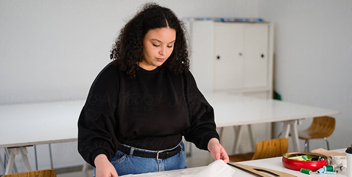 woman holding white tissue paper at a table
