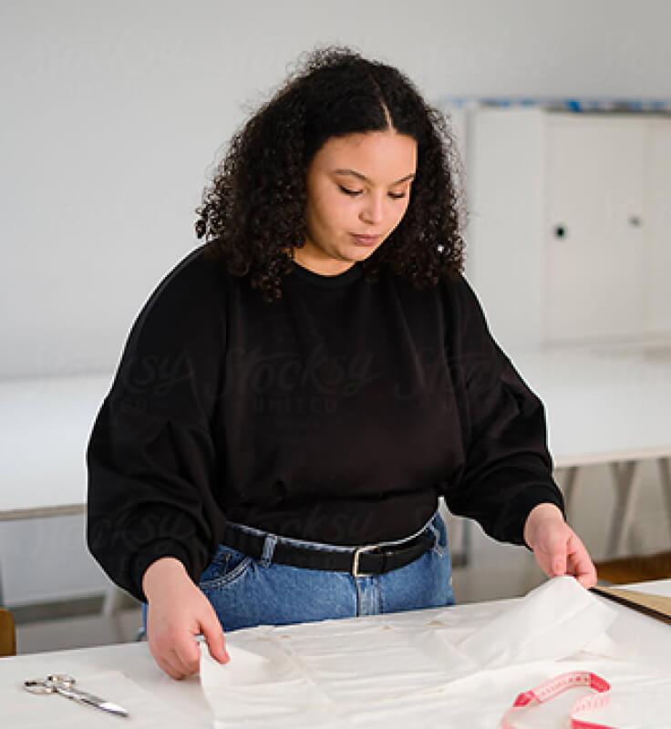 woman holding white tissue paper at a table