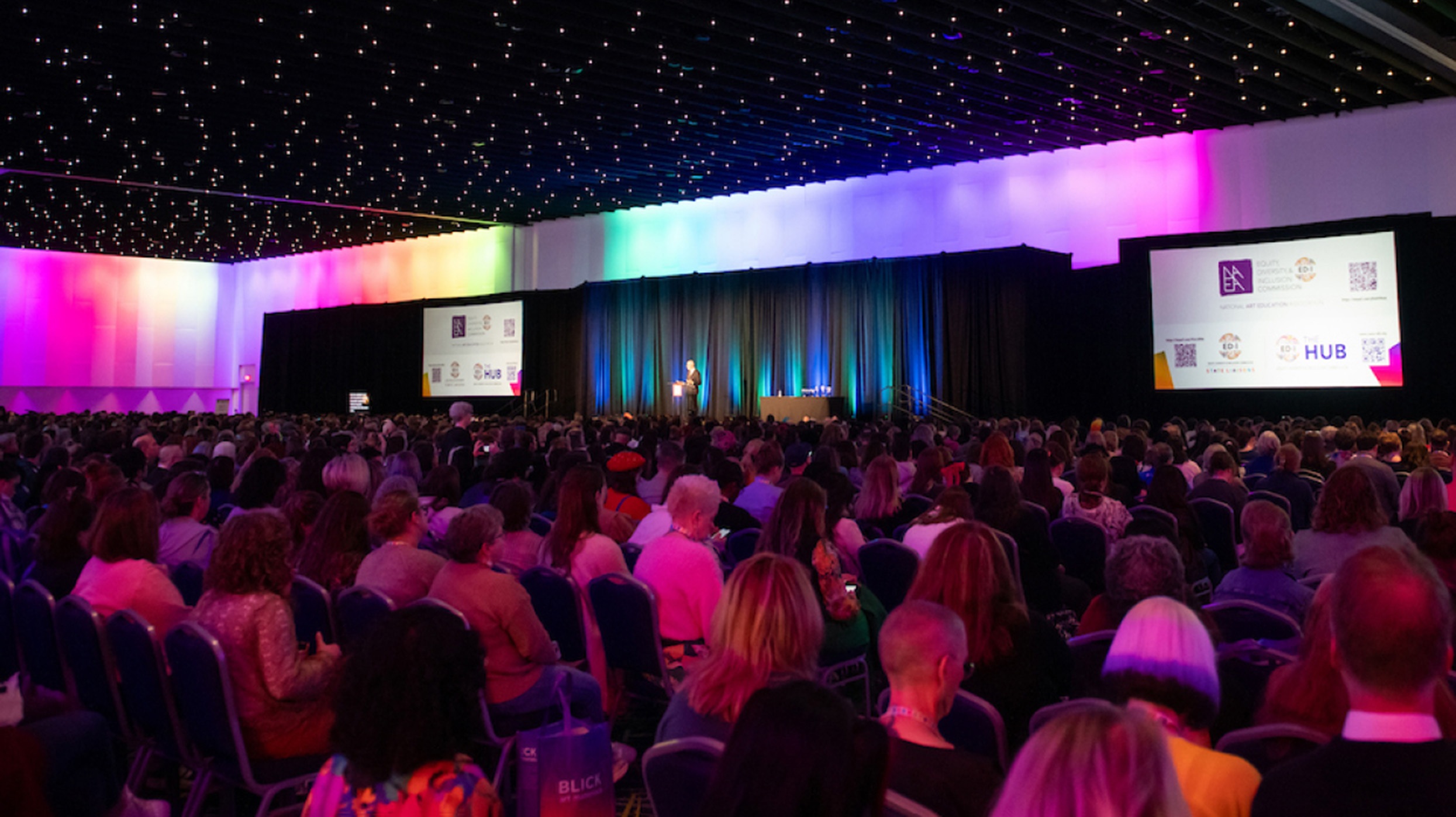 Photo of NAEA Convention attendees seated in an auditorium listening to a speech