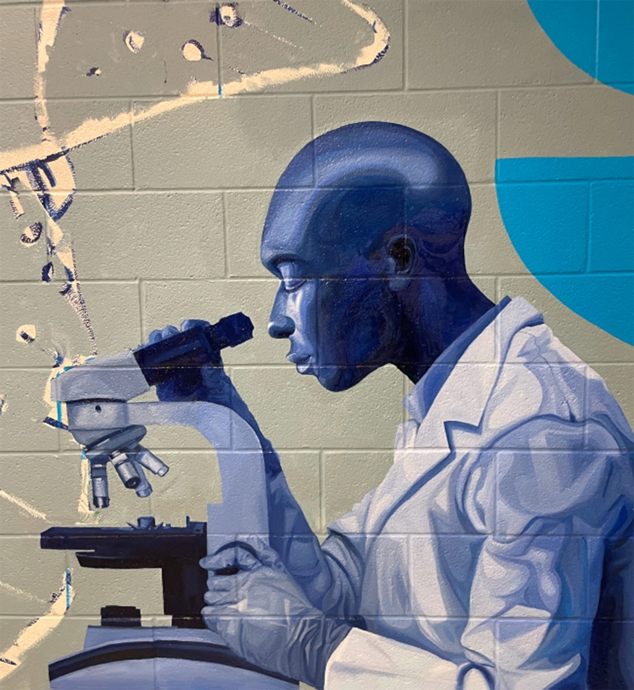 Mural depicting a man looking through a microscope
