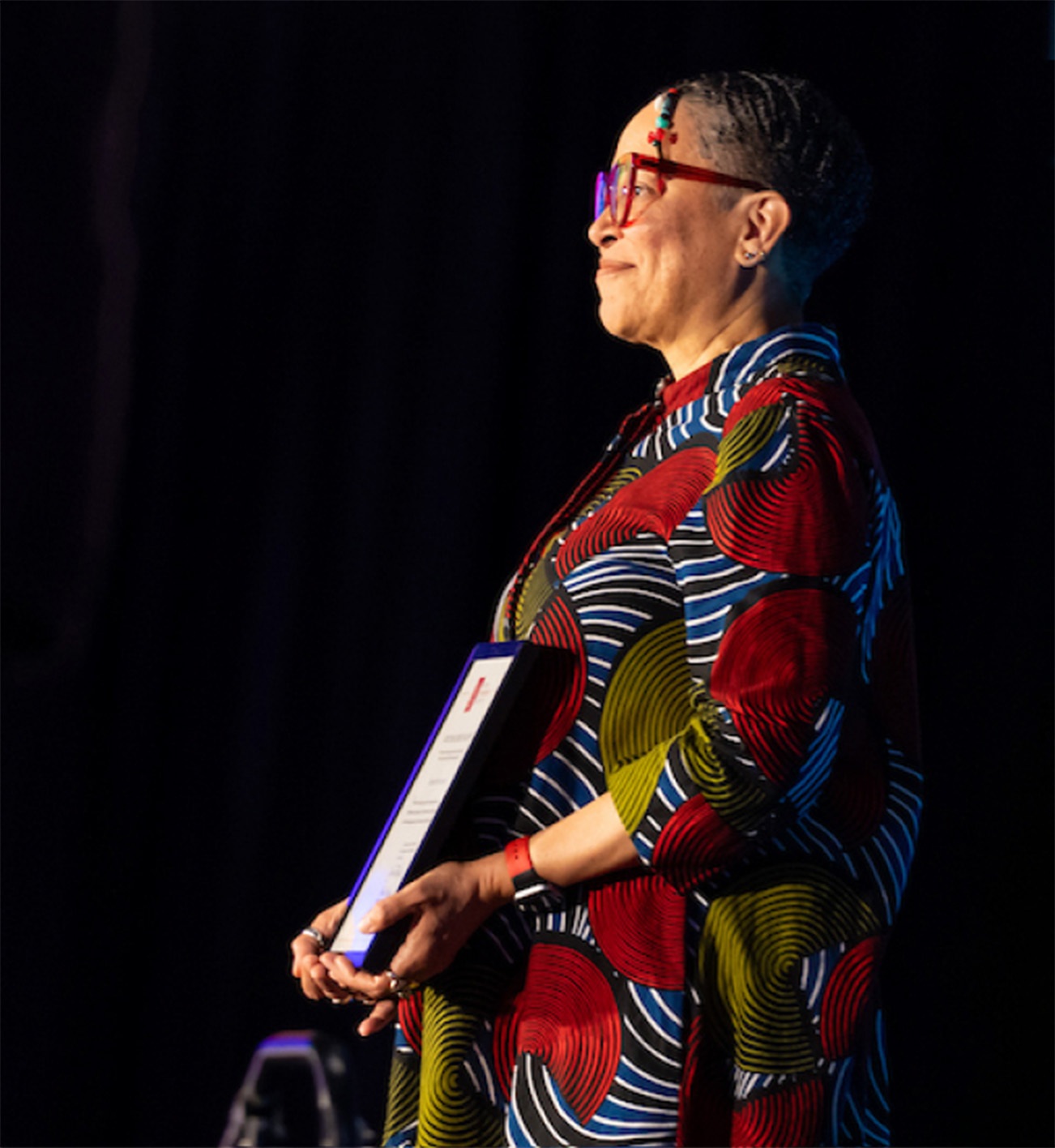 Photo of person accepting their award certificate